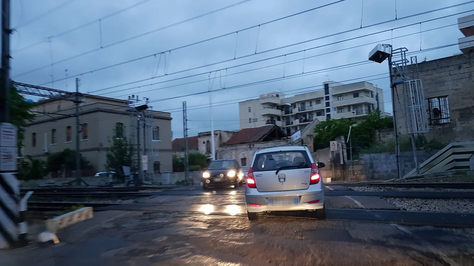 Street-level view of a level crossing in Italy