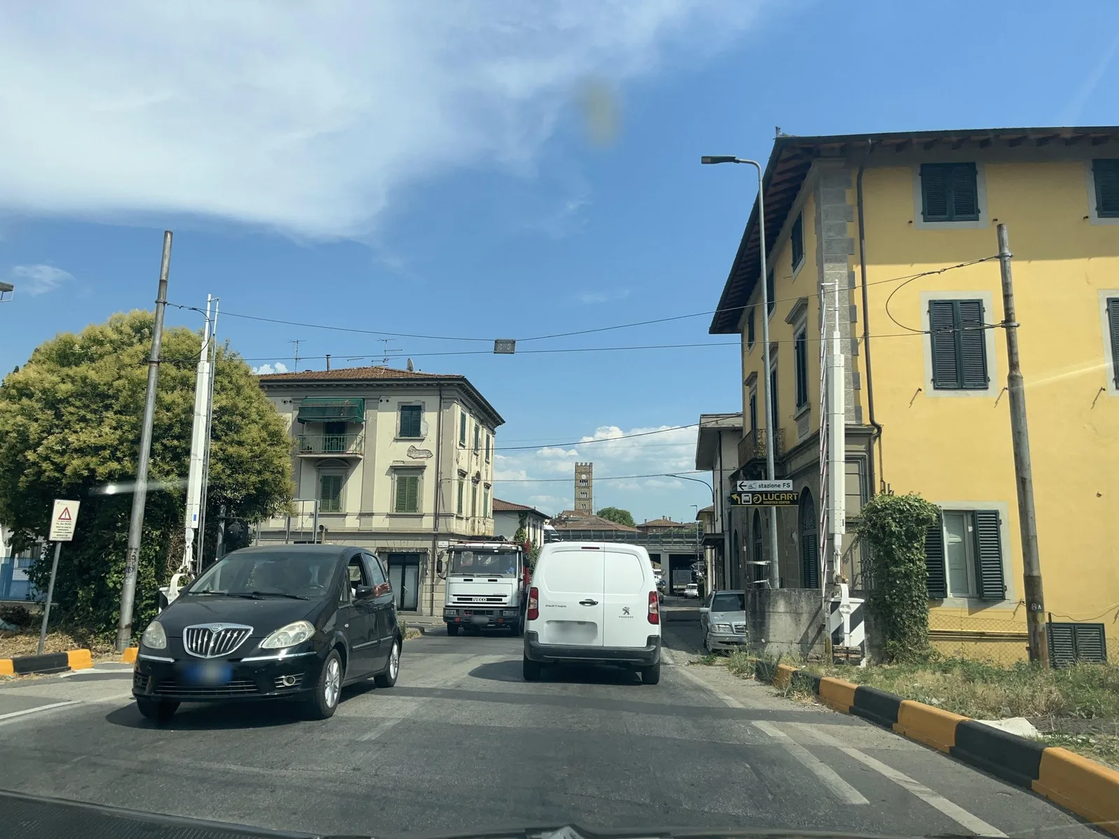 Street-level view of a level crossing in Italy