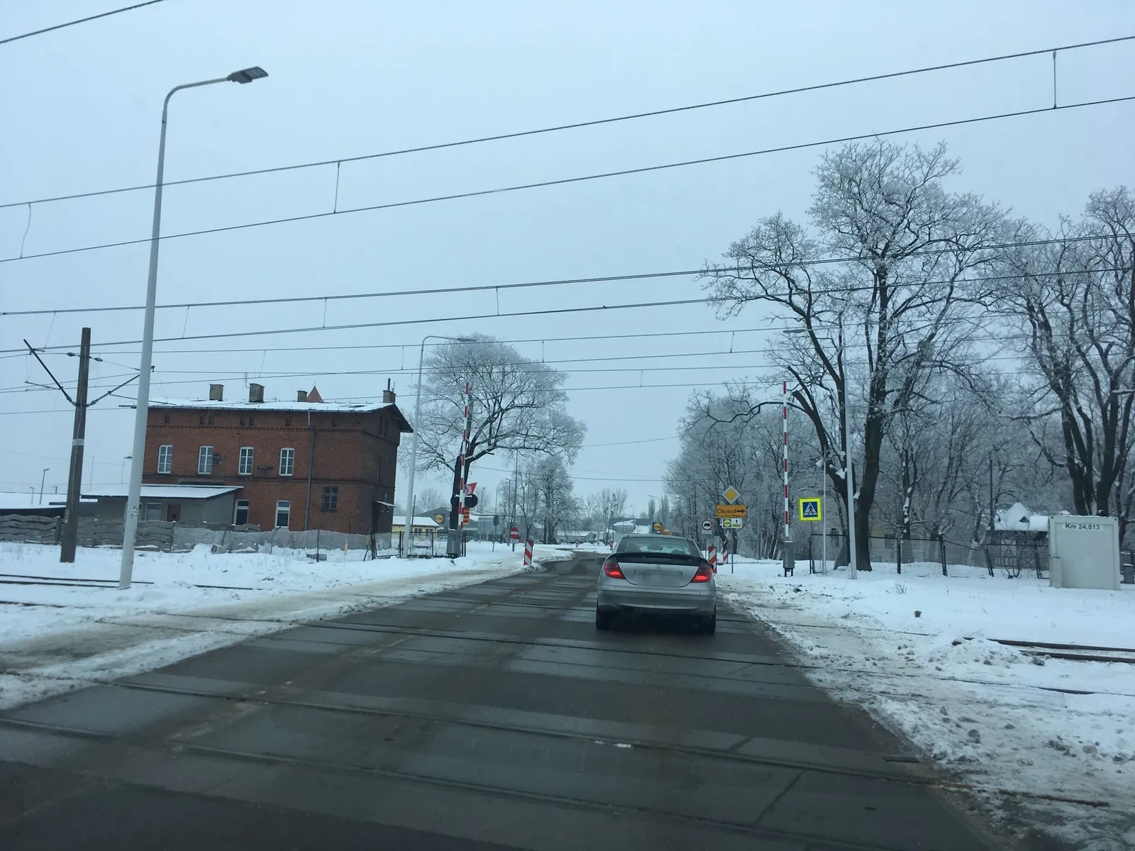 Street-level view of a level crossing in Poland