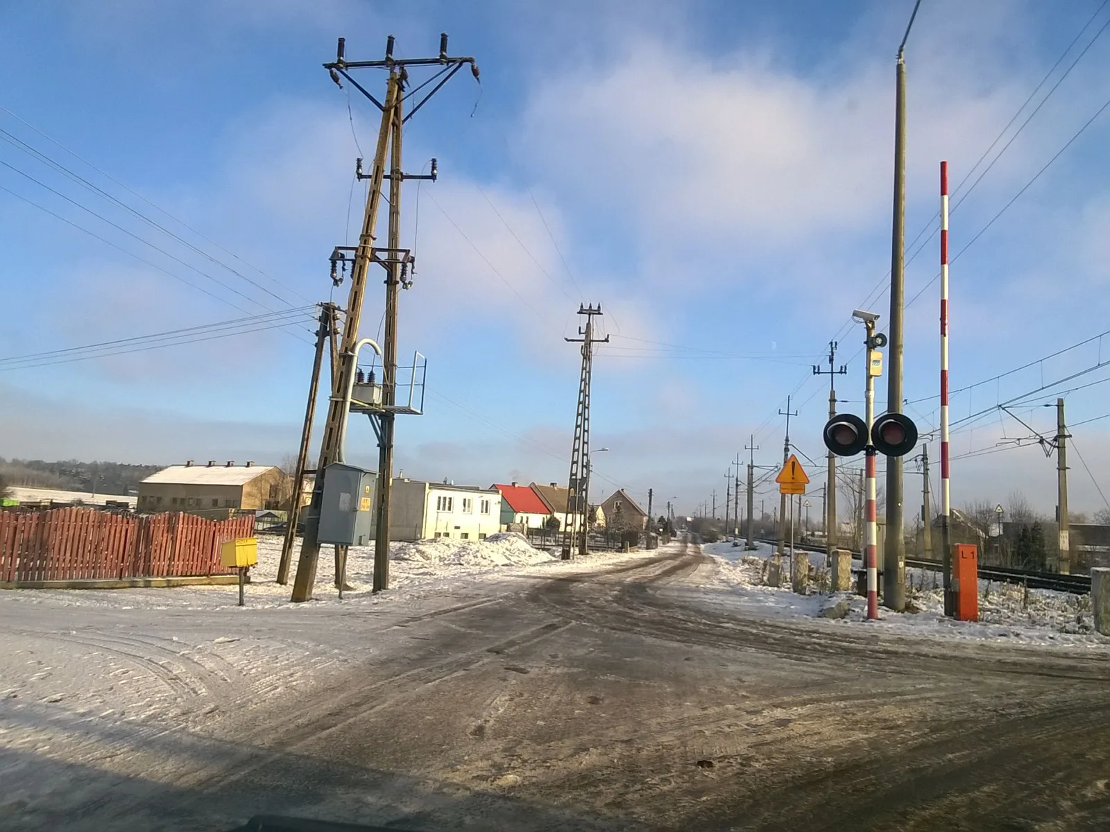 Street-level view of a level crossing in Poland