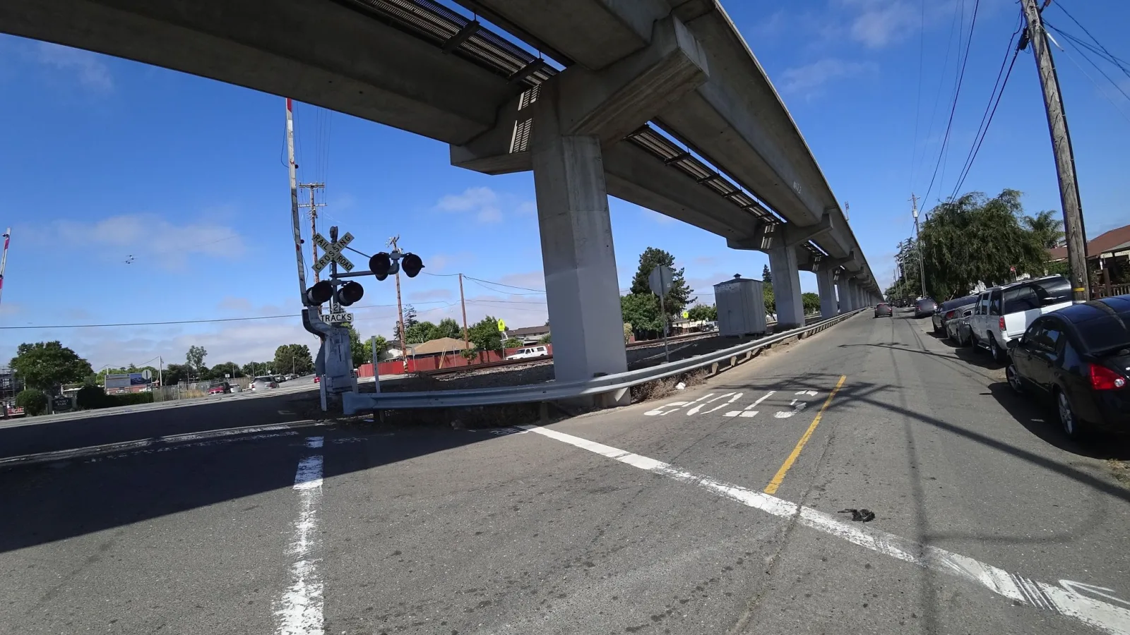 Street-level view of a highway-rail grade crossing in Hayward, California