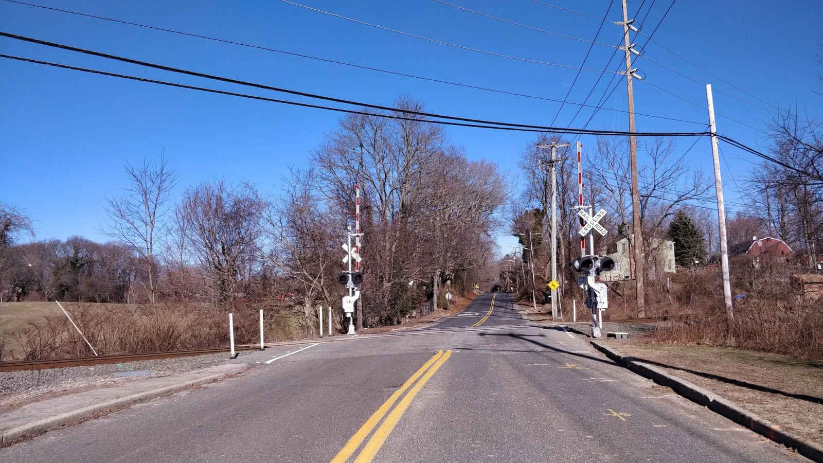 Street-level view of a highway-rail grade crossing on Long Island, New York