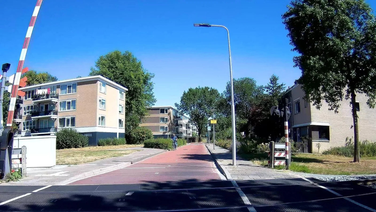 Street-level view of a level crossing in the Netherlands